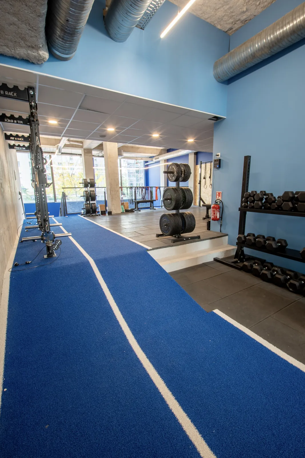 Piste de sled bleue, rack d'haltères et arbre à disques chez CrossFit HEKA Part-Dieu 2 à Lyon 3